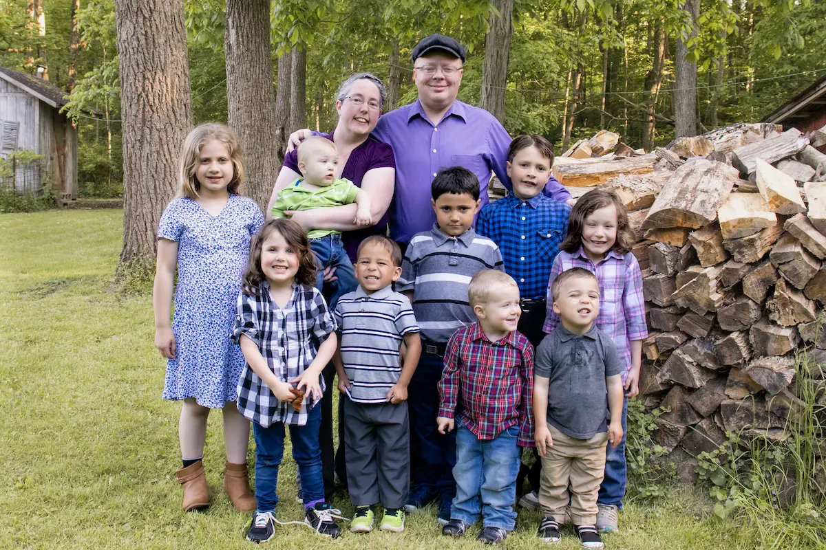 Jason and Amber Westover with their eight adopted children together in 2025 — the family behind everything he builds