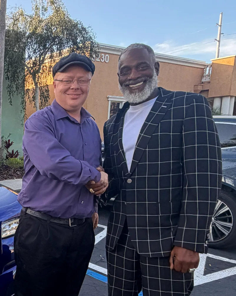 Jason Westover shaking hands with Myron Golden