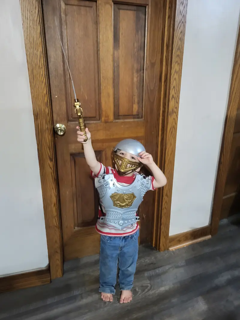 Z'kyan in full knight armor raising a sword — the next generation of the Westover mission